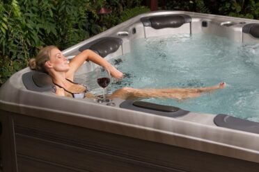 Woman relaxing in soothing waters of a hot tub.