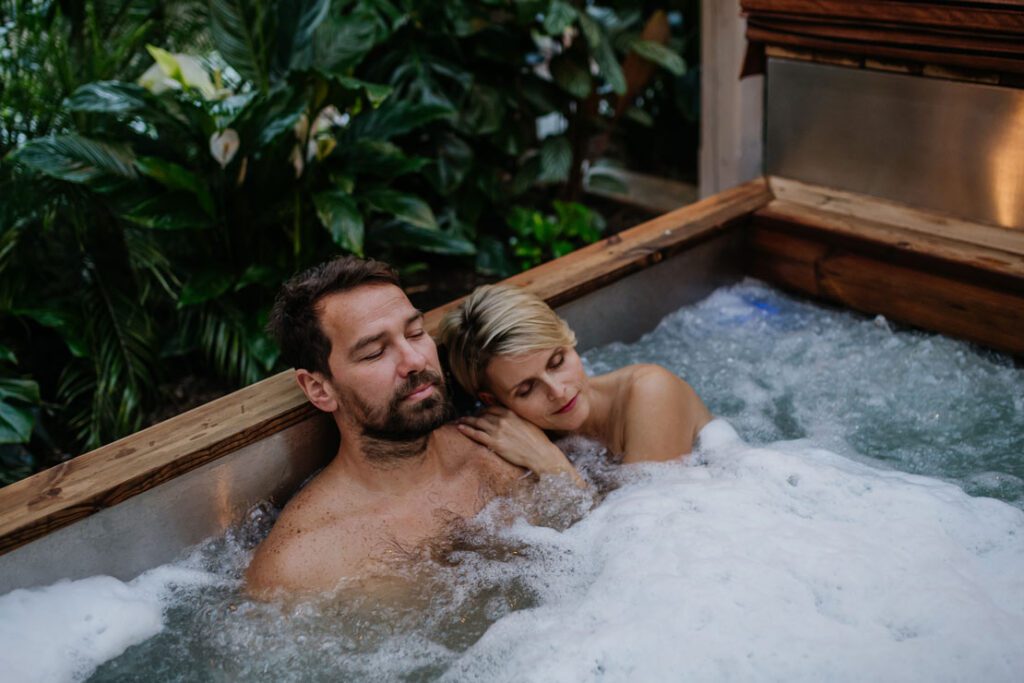 A couple relax in a hot tub in Surrey Uk after a stressful day