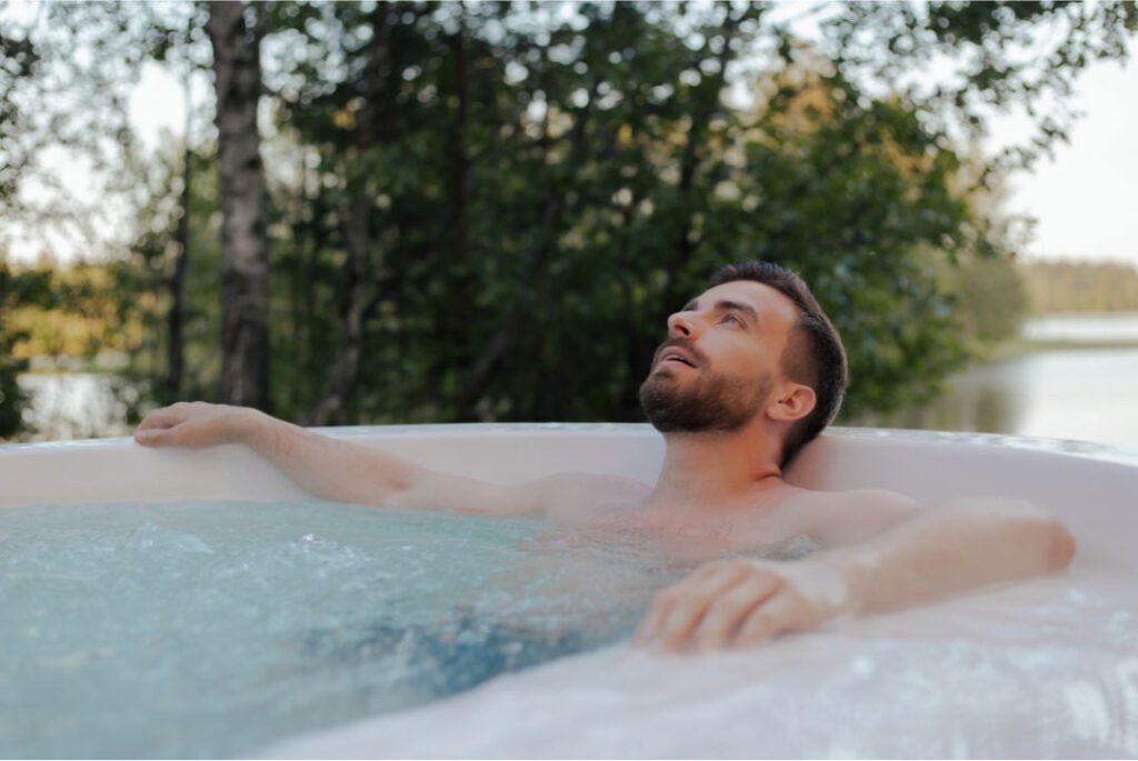 A man relaxing in hot tub the evening for mental health wellbeing