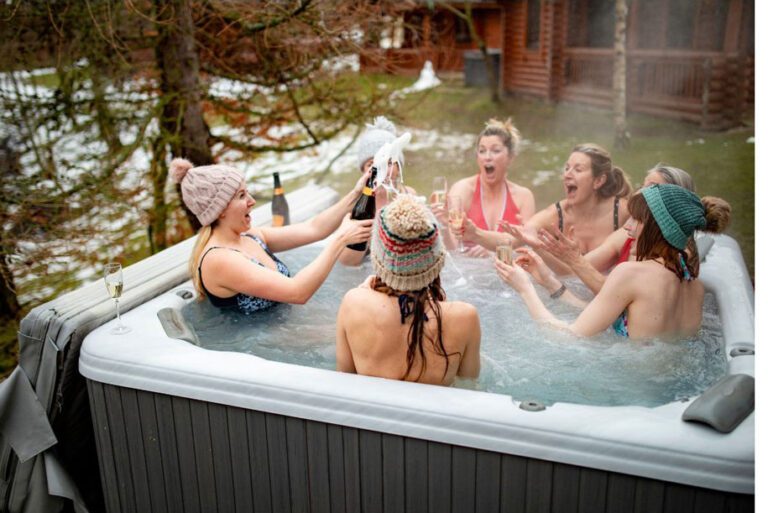 Friends in Surrey UK party in a back garden hot tub