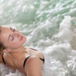 A women de-stresses her worries away whilst relaxing a hot tub