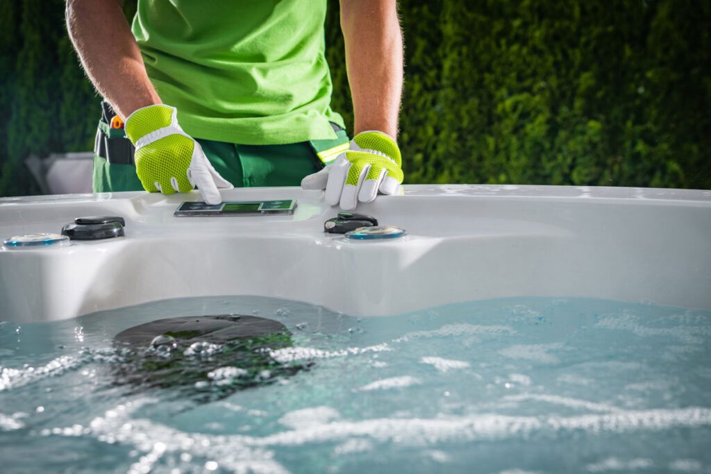 A Hot Tub owner in Surrey UK checks the water temperature before the kids use the spa.