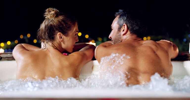 A couple enjoying their autumn evening in their hot tub in Surrey UK