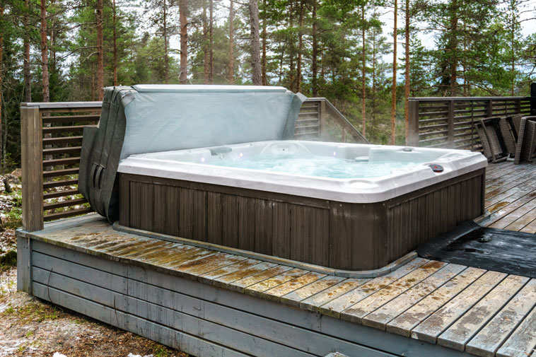 An open hot tub in winter, not being very energy efficient