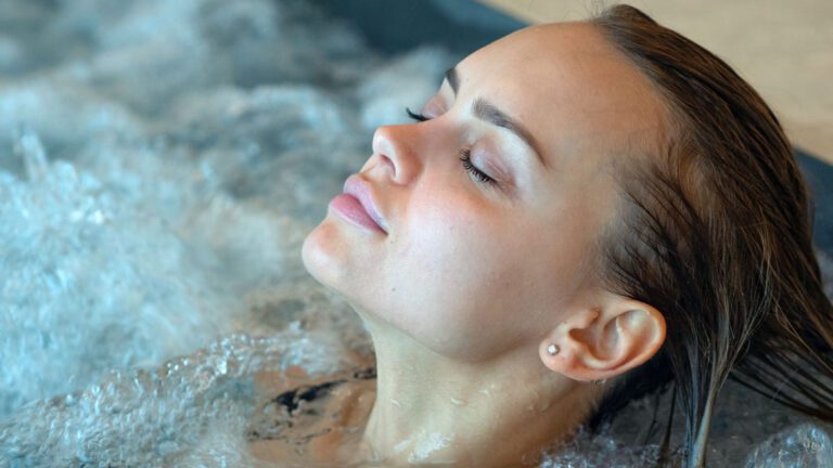 A women relaxes after a hydrotheraphy sesson in her Surrey UK Hot Tub