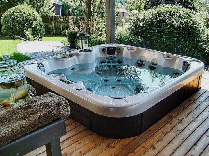 A l ovely hot tub in Surrey UK shows an impressive integration into a back garden